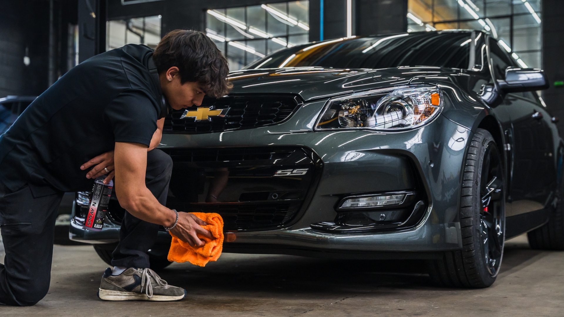 Chevrolet SS being hand-detailed by a Deluxe Detail technician
